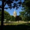 A peek through the trees at the Iowa State Capitol.