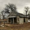 Brave standing 
1930's filling station 
Muskogee County, OK.